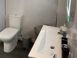 A bathroom with a toilet and sink at Fenton Drive in Wooler