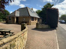 A house with a pathway and garden at Fenton Drive in Wooler