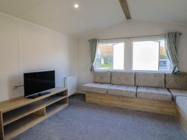 A living room with a sofa and television at WF32 - Jurassic Discovery in Charmouth