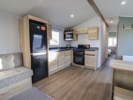 A kitchen with a refrigerator and oven at WF32 - Jurassic Discovery in Charmouth
