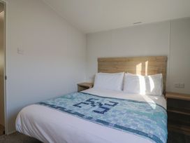 A bedroom with a bed and bedside table at WF32 - Jurassic Discovery Charmouth