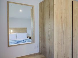 A bedroom with a mirror and a view of a bed at WF32 - Jurassic Discovery in Charmouth