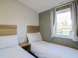 A bedroom with two beds and a window at WF32 - Jurassic Discovery, Charmouth