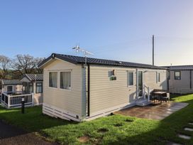 A mobile home with a patio and furniture at Jurassic Discovery in Charmouth