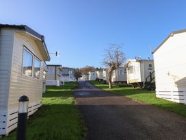 Mobile homes along a pathway at Jurassic Discovery in Charmouth