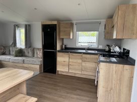 A kitchen with a sofa and dining table at Jurassic Discovery in Charmouth