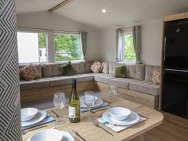 A living room with dining table and sofa at Jurassic Discovery in Charmouth