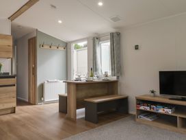 A dining room with a table and benches at Jurassic Discovery in Charmouth