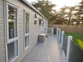 A deck area with windows and storage box at Orchid 9 Christchurch