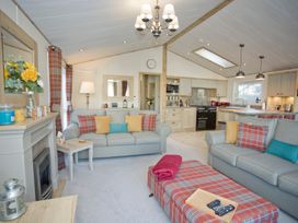 A living room with sofas and a coffee table at Orchid 9 Christchurch