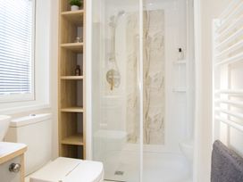 A bathroom with a shower and toilet at Orchid 9 in Christchurch