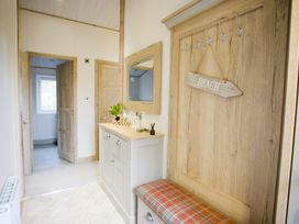 A hallway with a console table and hooks at Orchid 9 Christchurch