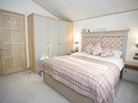 A bedroom with a bed and wardrobe at Orchid 9 Christchurch