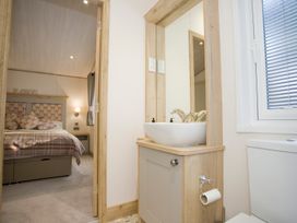 A bathroom with a sink and toilet at Orchid 9 in Christchurch