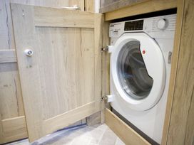 A washing machine inside a cupboard at Orchid 9 in Christchurch