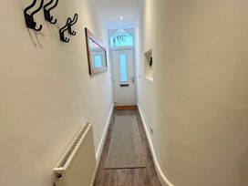 A hallway with coat hooks and a door at The Weymouth House in Weymouth