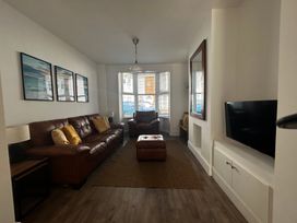 A living room with a sofa and armchairs at The Weymouth House in Weymouth