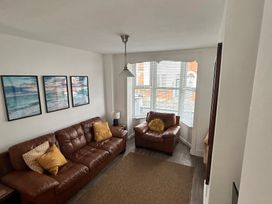 A living room with a sofa and an armchair at The Weymouth House in Weymouth