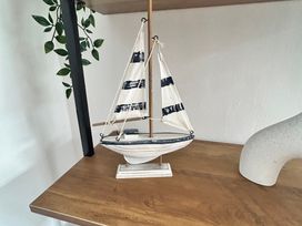 A decorative sailboat on a shelf at The Weymouth House Weymouth