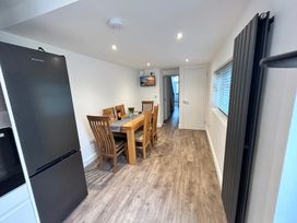 A dining room with a table and chairs at The Weymouth House in Weymouth