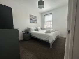 A bedroom with a bed and nightstand at The Weymouth House in Weymouth