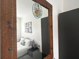 A bedroom with a bed and wall art at The Weymouth House in Weymouth