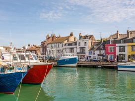 Boats in the harbor with buildings in the background at The Weymouth House in Weymouth