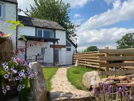An outdoor area with a stone path and flowers at The Haven in Penrith