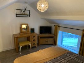 A bedroom with a bed and desk at The Haven in Penrith