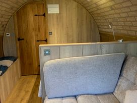 A room with a sofa and wooden door at Cosy Escape in Sheerness