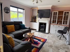 A living room with a sofa and coffee table at Cherry Chirp Cottage Enniskillen