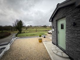A view of the entrance with a door and gravel area at Cherry Chirp Cottage Enniskillen