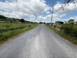 A road with grass on the sides at Cherry Chirp Cottage Enniskillen