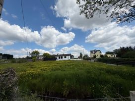 An outdoor view with houses and grass at Cherry Chirp Cottage Enniskillen