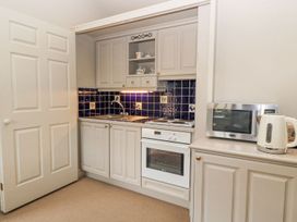 A kitchen with cabinets and appliances at Foxhill Farm Barn Cheltenham