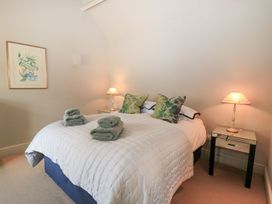 A bedroom with a bed and decorative pillows at Foxhill Farm Barn in Cheltenham
