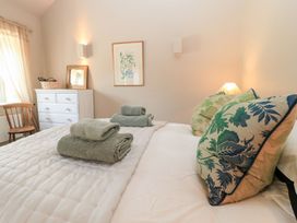 A bedroom with a bed and towels placed on pillows at Foxhill Farm Barn in Cheltenham