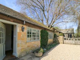 An exterior view of a building with a pathway and garden at Foxhill Farm Barn Cheltenham