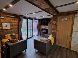 A snug with sofas and a fireplace at Birdsong lodge near Sutton-On-Sea