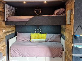 A bedroom with a bunk bed and sofa bed at Birdsong lodge near Hawthorn Farm in Sutton-On-Sea