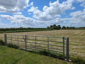 A field with a gate and hedges at Birdsong lodge near Hawthorn Farm near Sutton-On-Sea