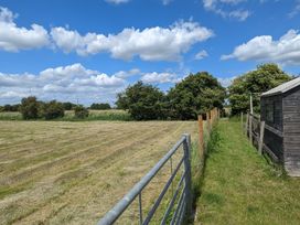A field with a gate and shed at Birdsong lodge near Hawthorn Farm near Sutton-On-Sea