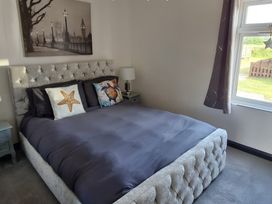 A bedroom with a bed and nightstand at Waterside Lodge in Mablethorpe