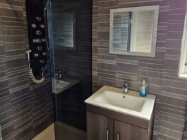 A bathroom with a shower and sink at Waterside Lodge in Mablethorpe