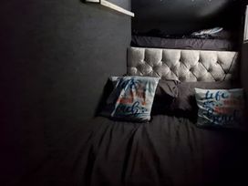 A bedroom with a bed and pillows at Waterside Lodge in Mablethorpe