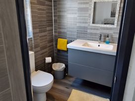 A bathroom with a toilet and sink at Waterside Lodge in Mablethorpe