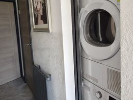 A laundry room featuring a door and a dryer at Waterside Lodge in Mablethorpe