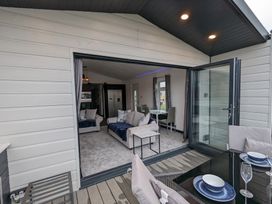 A living room with sofas and dining area at Waterside Lodge in Mablethorpe