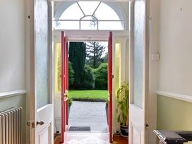 An entrance hall with front doors opening to a garden at Fountain Hill House Londonderry