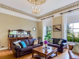 A living room with seating, a coffee table, and decorative elements at Fountain Hill House in Londonderry
